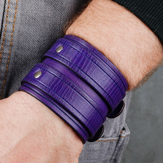 Close view of the purple cuff showing the stacked buckle straps on a wrist