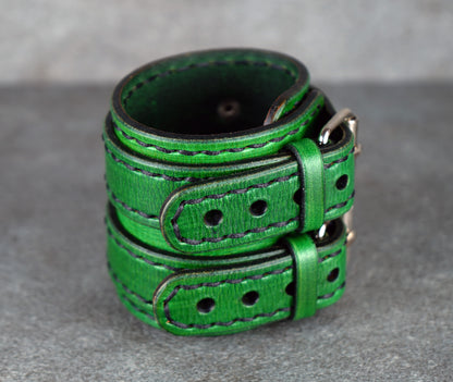Green leather belt on a gray surface