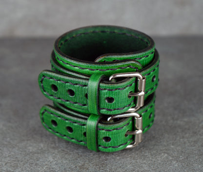 Green leather belt on a gray surface