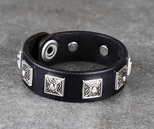 Black leather bracelet with silver metal accents