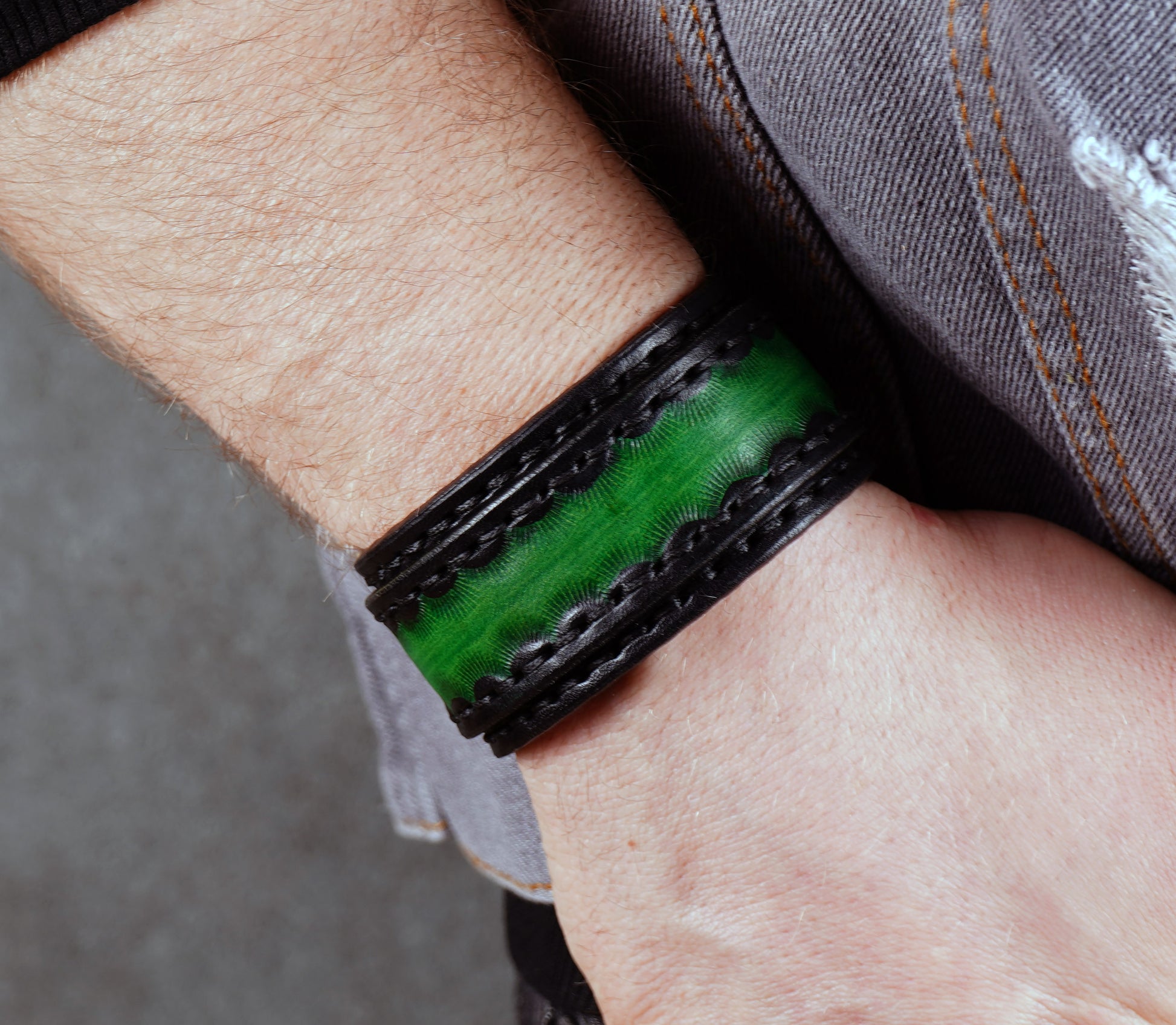 handmade black green leather cuff bracelet close up textured vegetable tanned leather