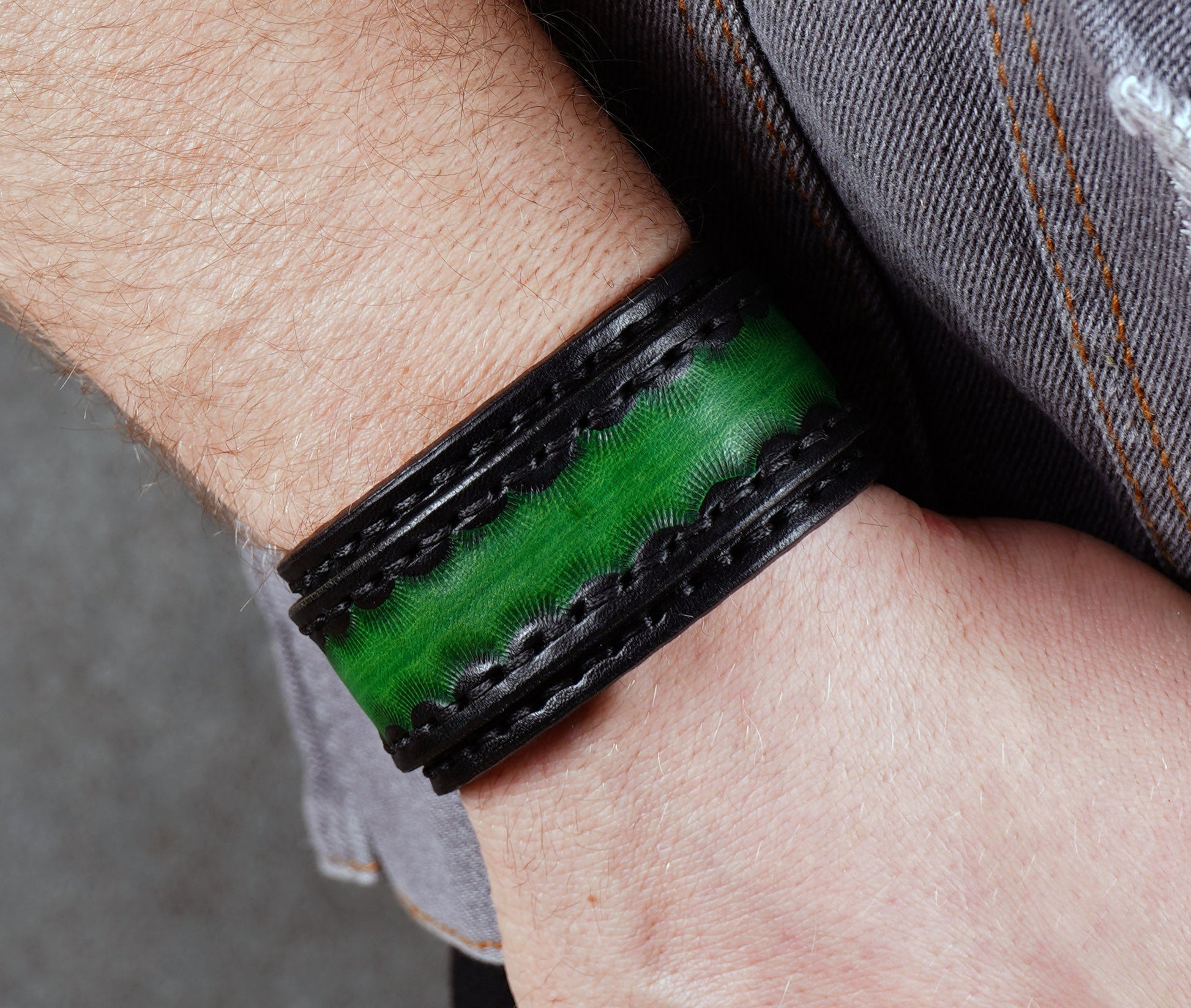 handmade black green leather cuff bracelet close up textured vegetable tanned leather