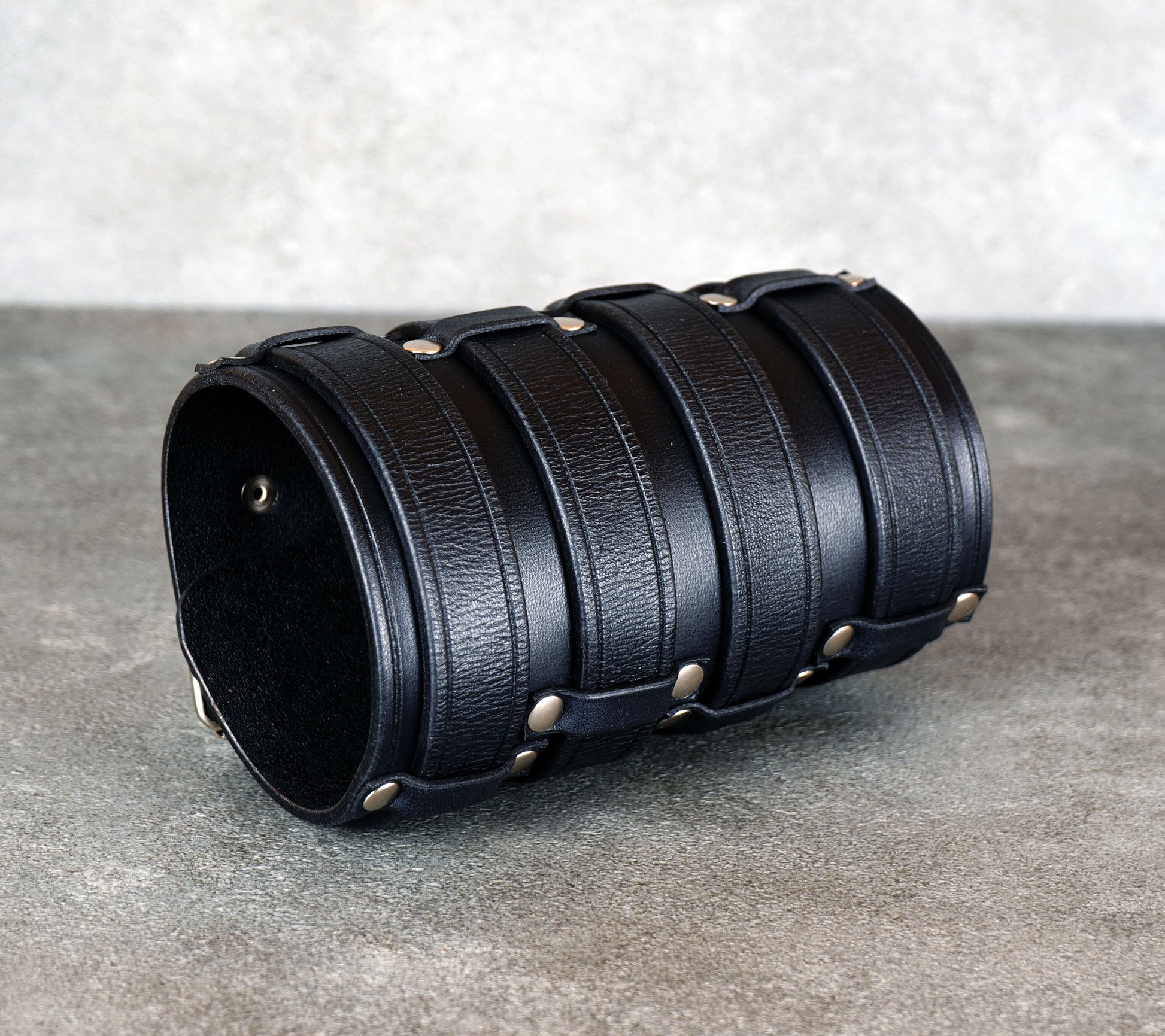 Wide black leather cuff bracelet handmade from vegetable-tanned leather, minimalist design