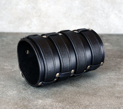 Wide black leather cuff bracelet handmade from vegetable-tanned leather, minimalist design