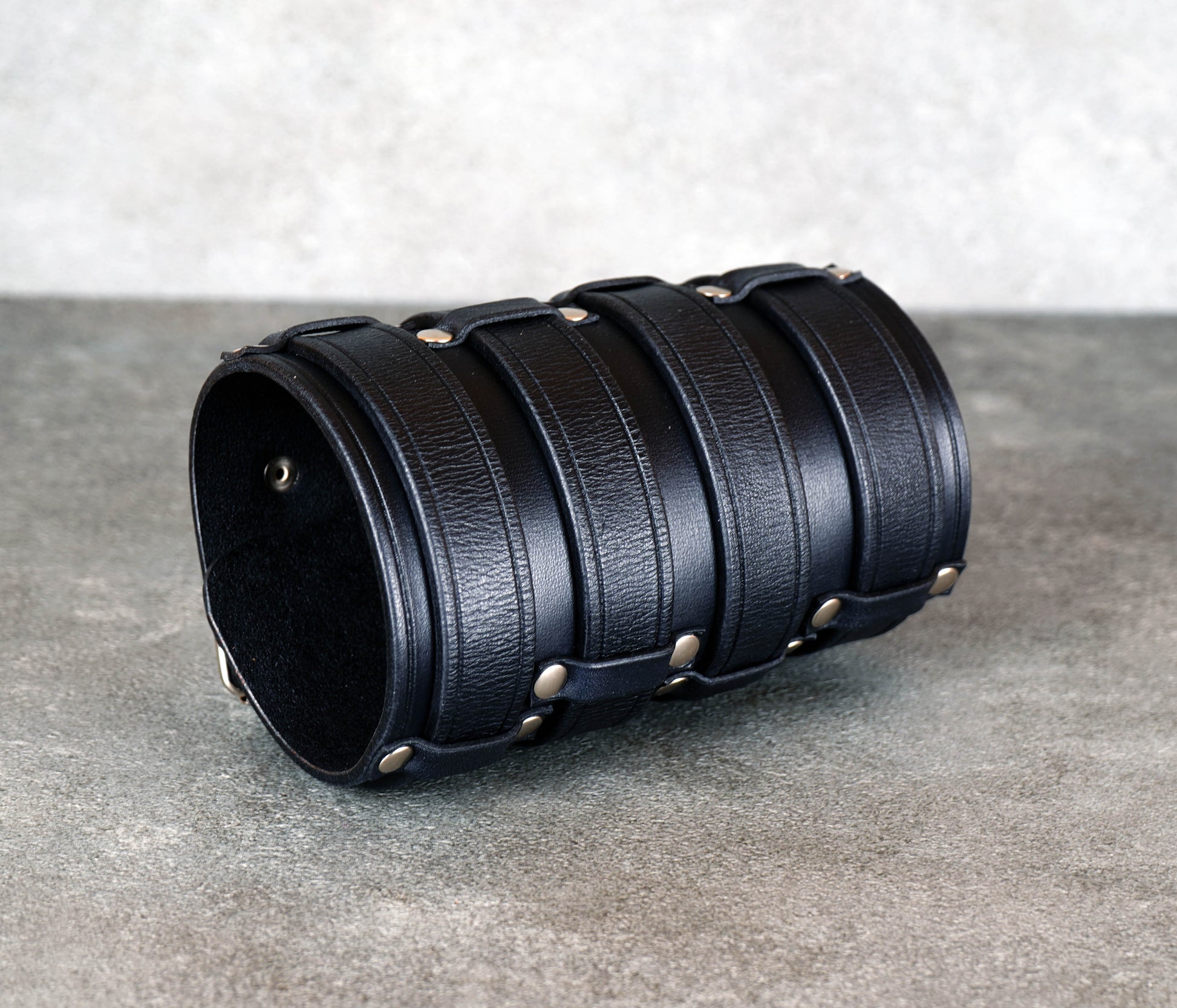 Wide black leather cuff bracelet handmade from vegetable-tanned leather, minimalist design