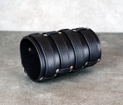 Wide black leather cuff bracelet handmade from vegetable-tanned leather, minimalist design