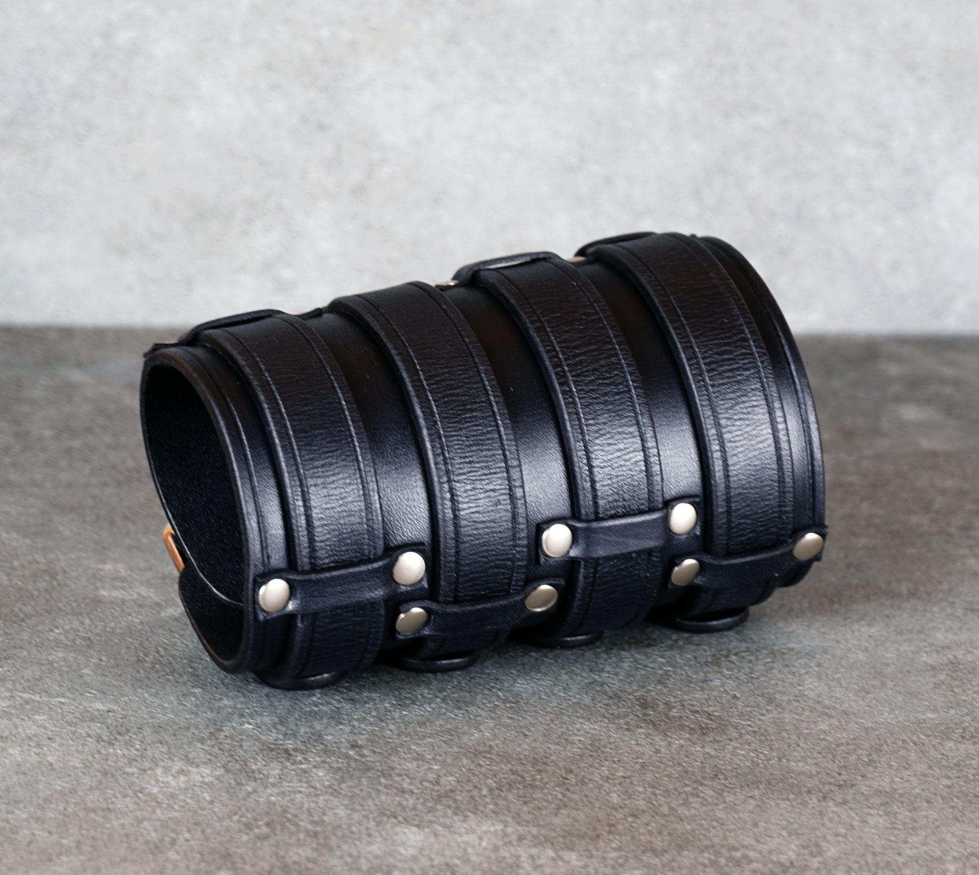 Wide black leather cuff bracelet handmade from vegetable-tanned leather, minimalist design