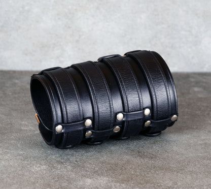 Wide black leather cuff bracelet handmade from vegetable-tanned leather, minimalist design