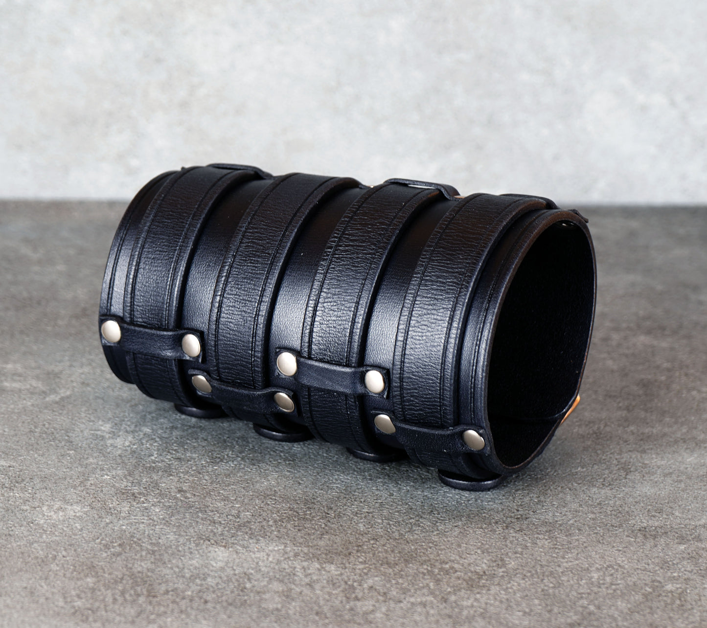 Wide black leather cuff bracelet handmade from vegetable-tanned leather, minimalist design