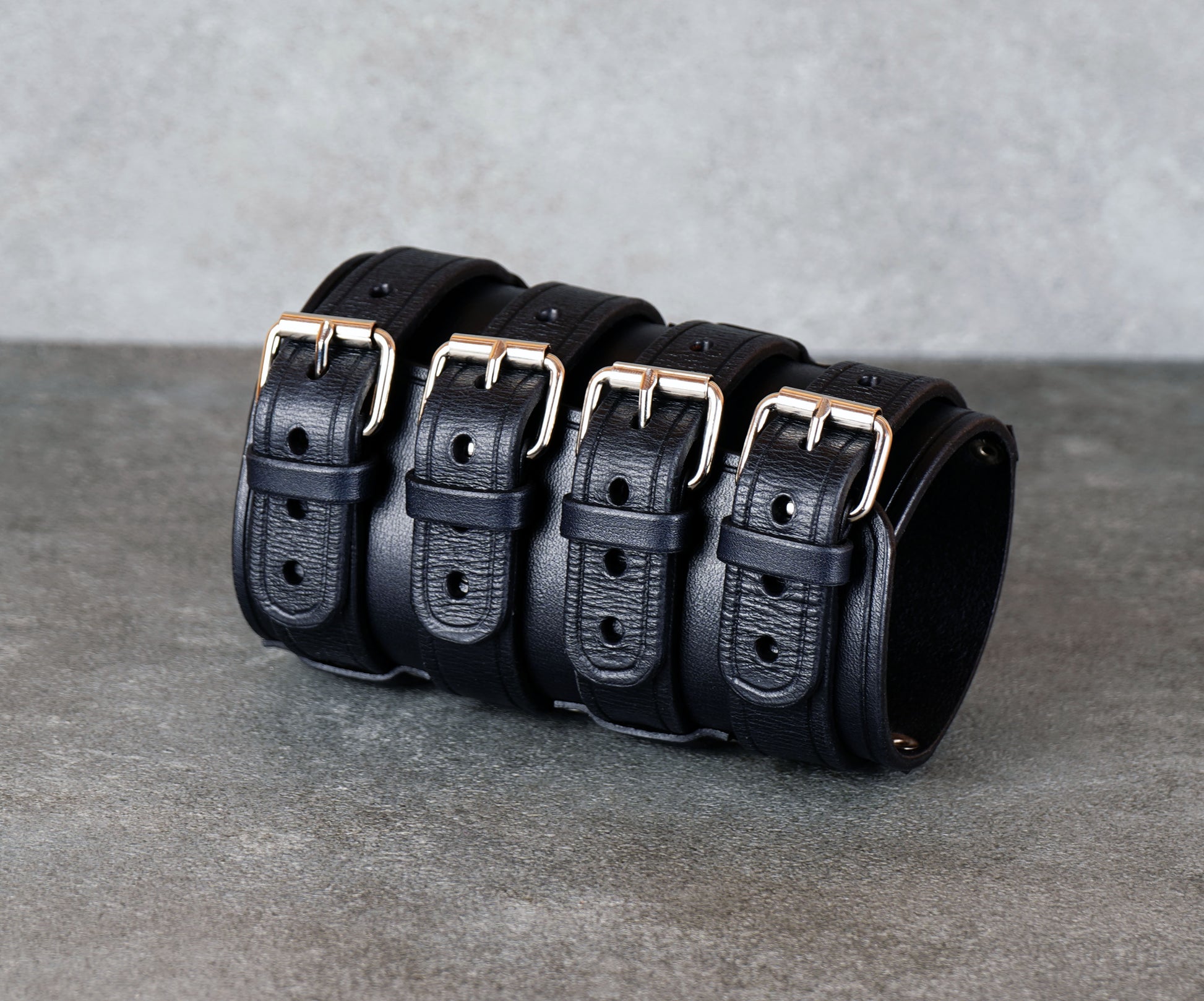 Wide black leather cuff bracelet handmade from vegetable-tanned leather, minimalist design