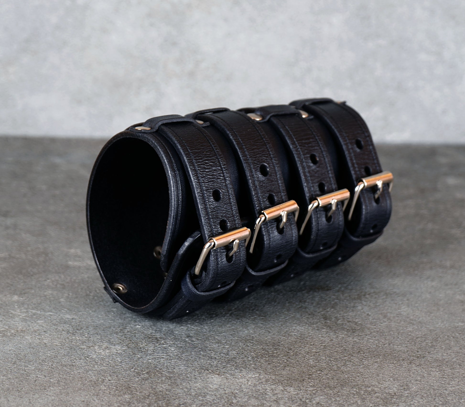 Wide black leather cuff bracelet handmade from vegetable-tanned leather, minimalist design
