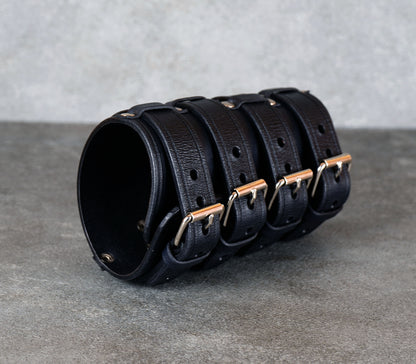 Wide black leather cuff bracelet handmade from vegetable-tanned leather, minimalist design