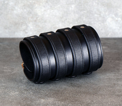 Wide black leather cuff bracelet handmade from vegetable-tanned leather with minimalist design