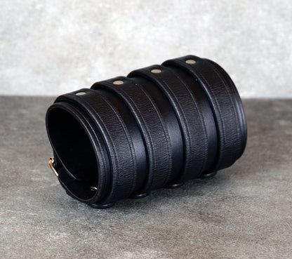 Wide black leather cuff bracelet handmade from vegetable-tanned leather with minimalist design