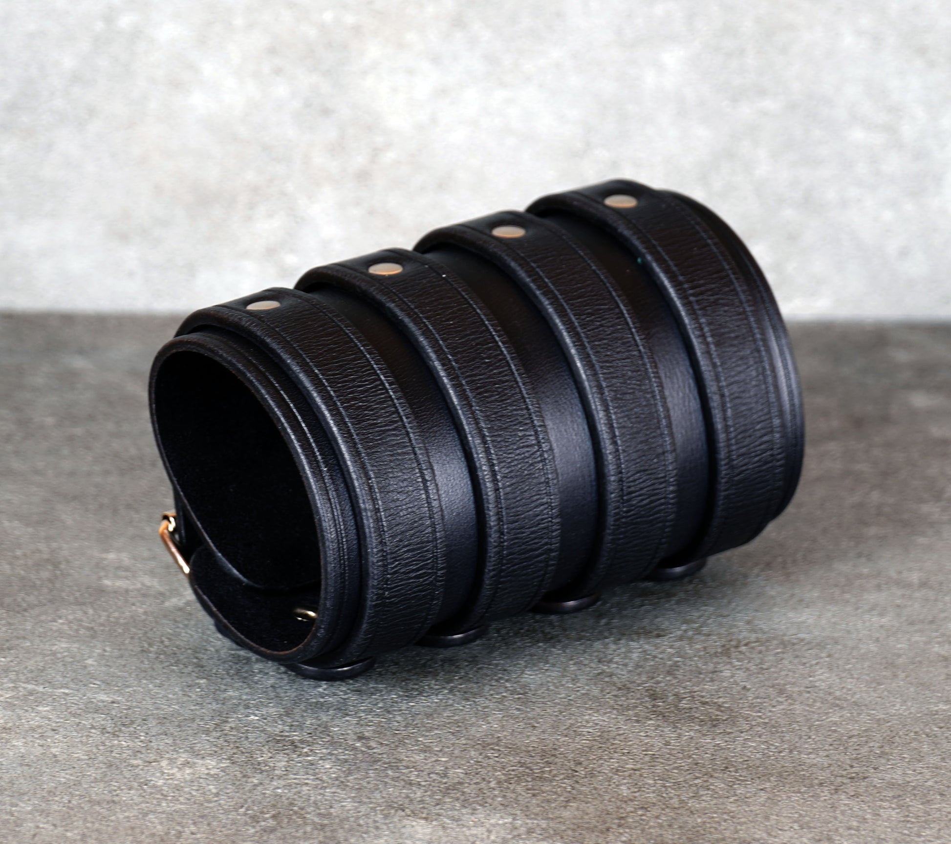 Wide black leather cuff bracelet handmade from vegetable-tanned leather with minimalist design