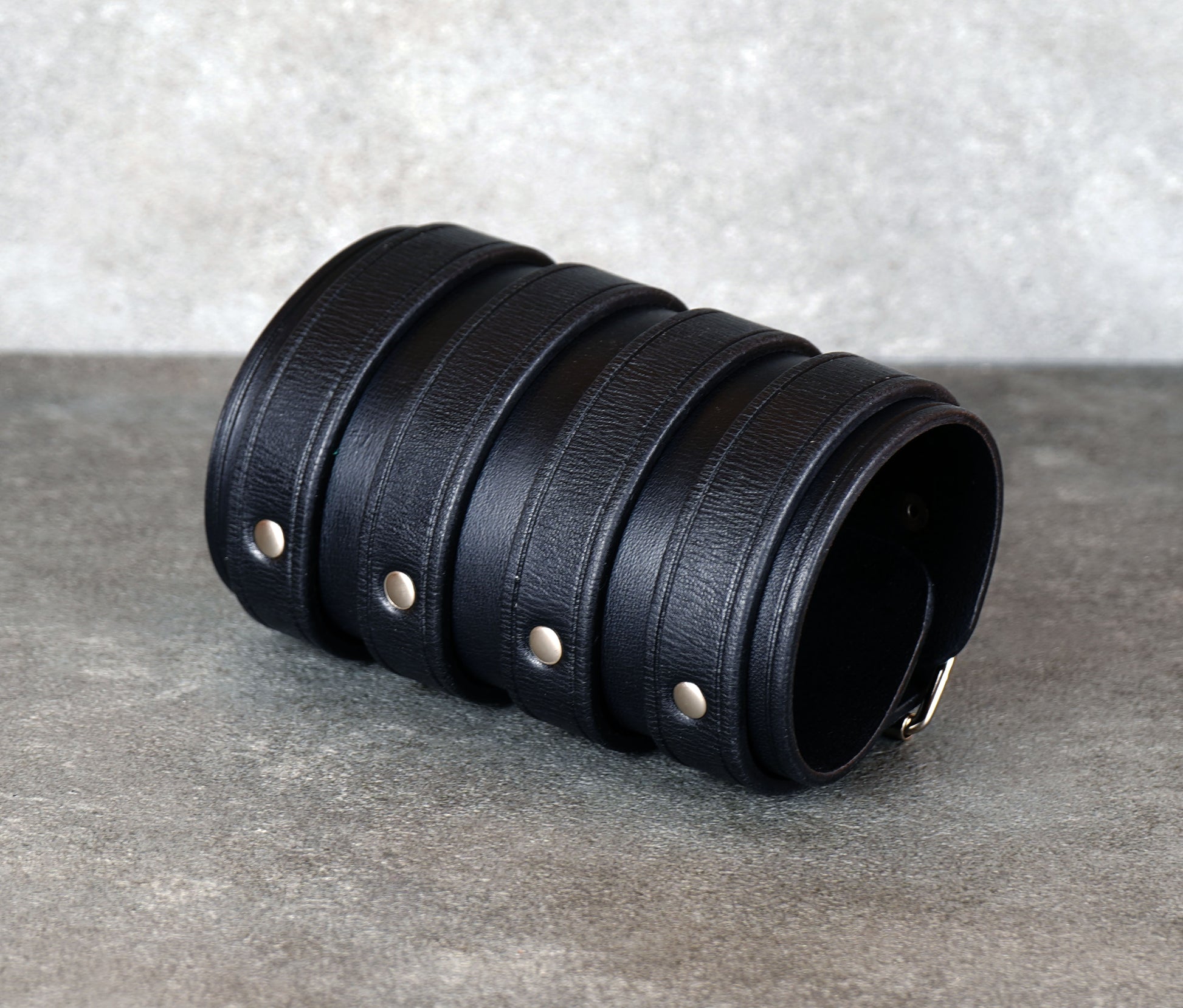 Wide black leather cuff bracelet handmade from vegetable-tanned leather with minimalist design