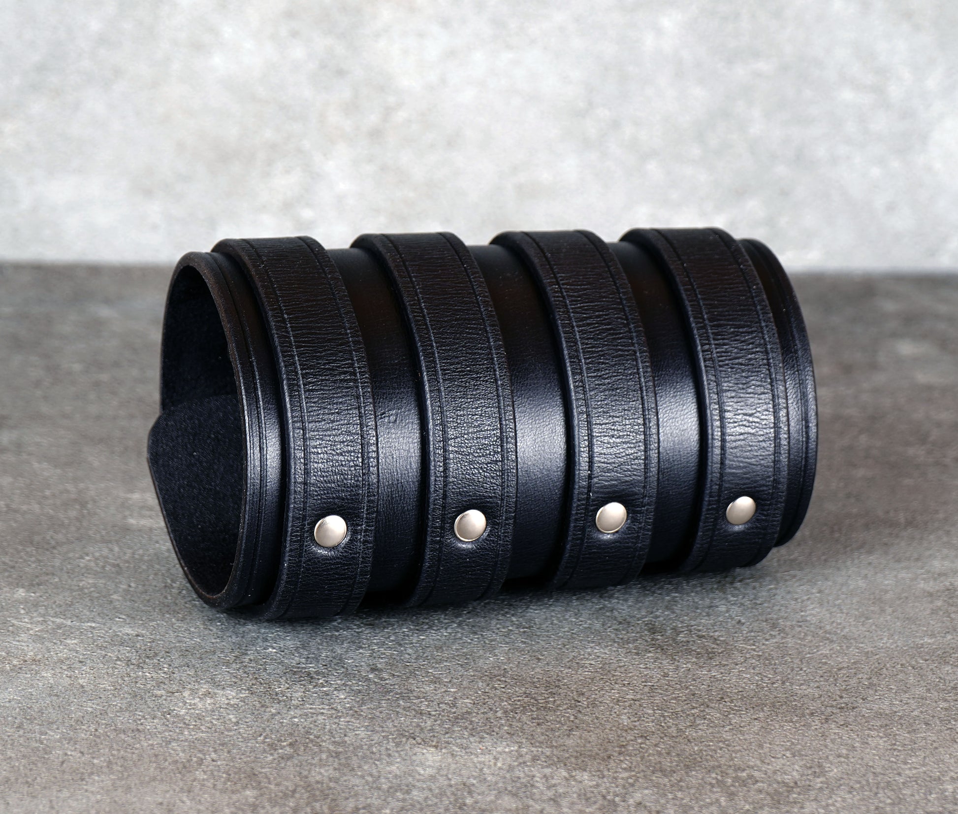 Wide black leather cuff bracelet handmade from vegetable-tanned leather with minimalist design