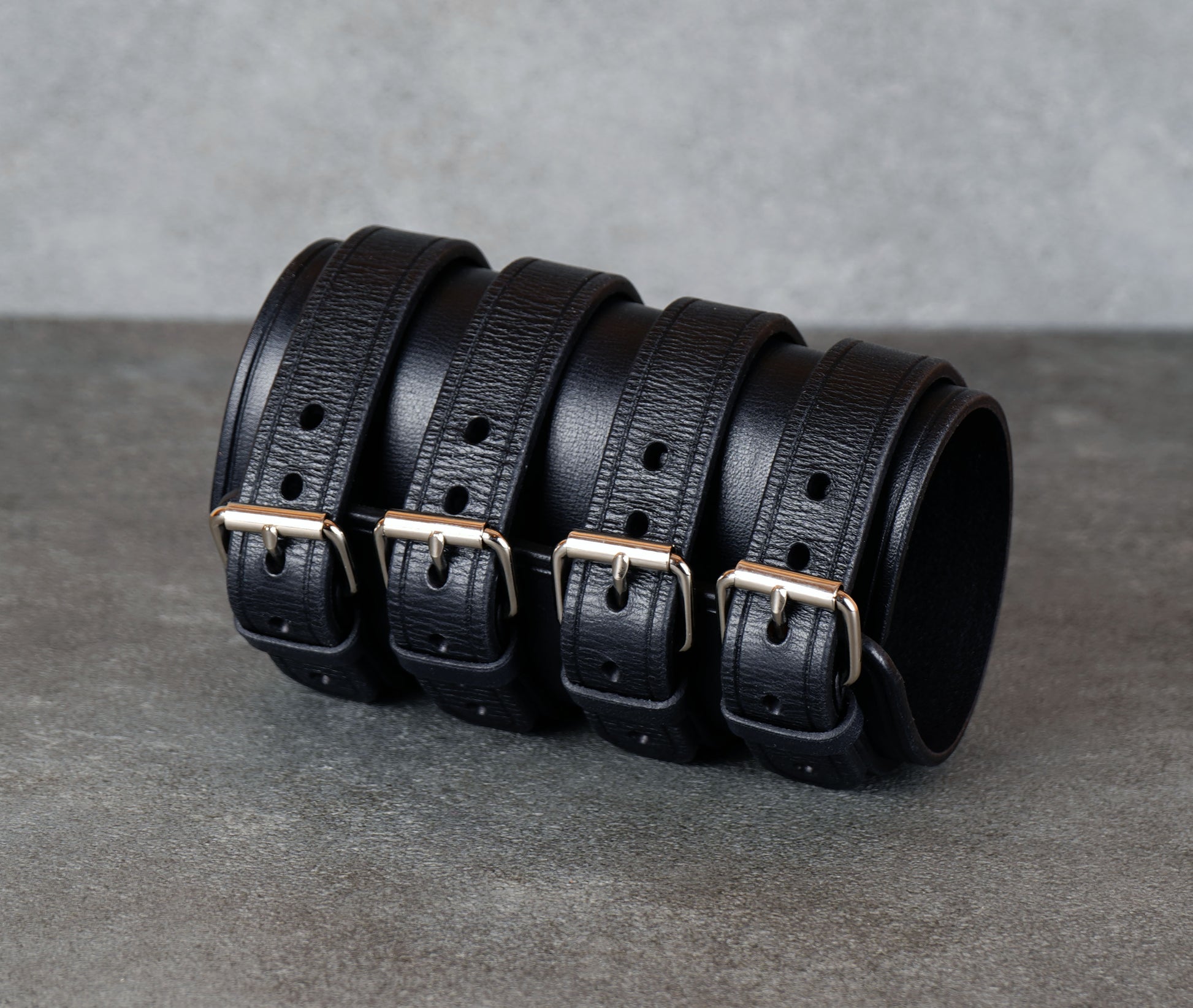 Wide black leather cuff bracelet handmade from vegetable-tanned leather with minimalist design