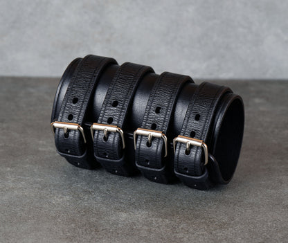 Wide black leather cuff bracelet handmade from vegetable-tanned leather with minimalist design