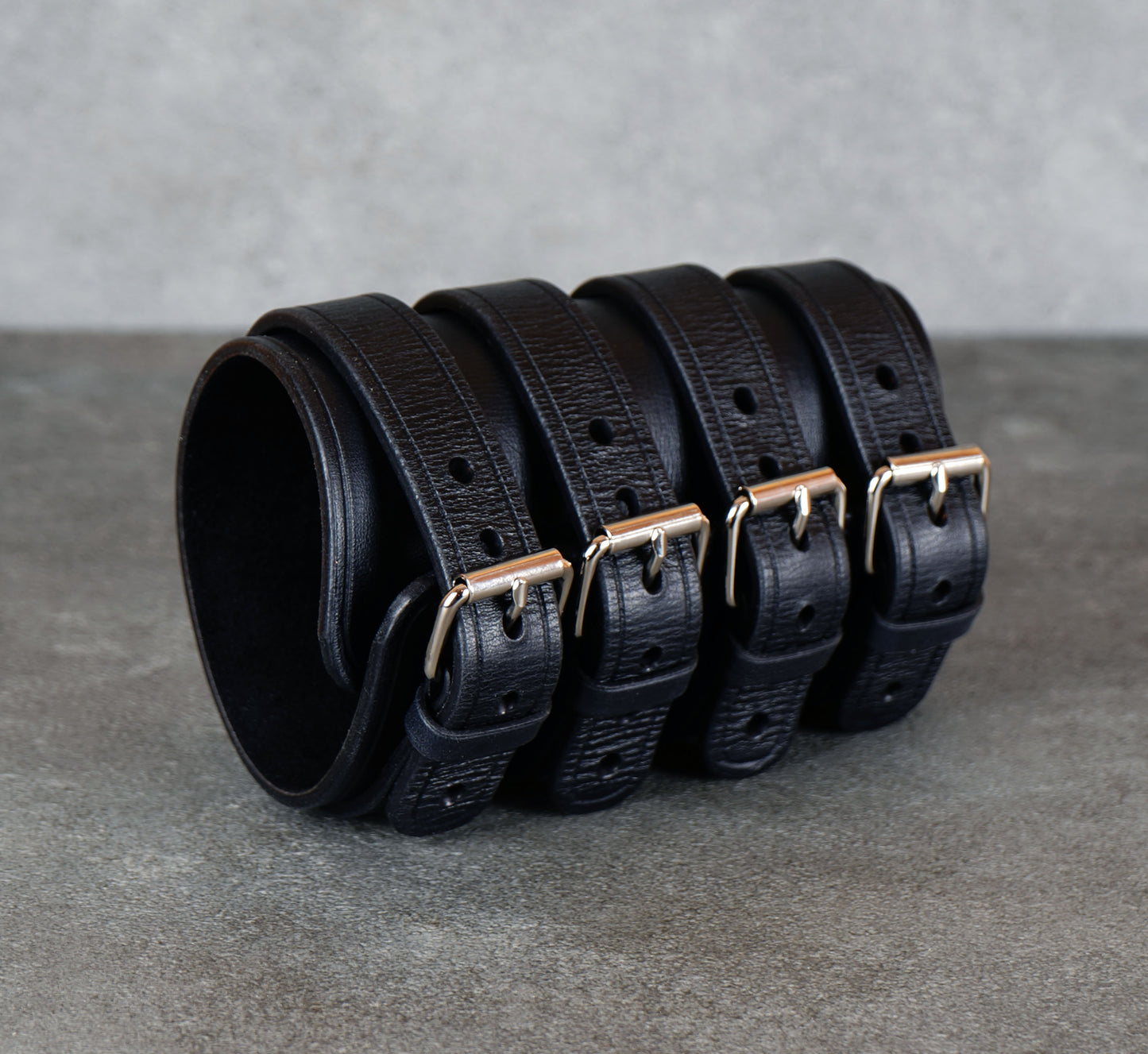 Wide black leather cuff bracelet handmade from vegetable-tanned leather with minimalist design