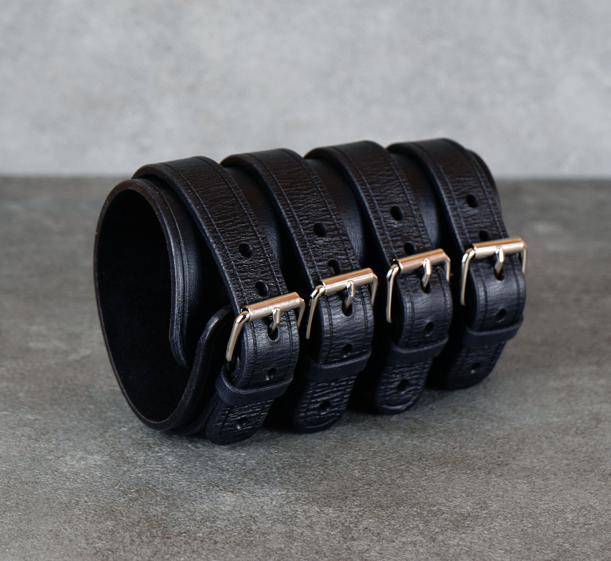 Wide black leather cuff bracelet handmade from vegetable-tanned leather with minimalist design