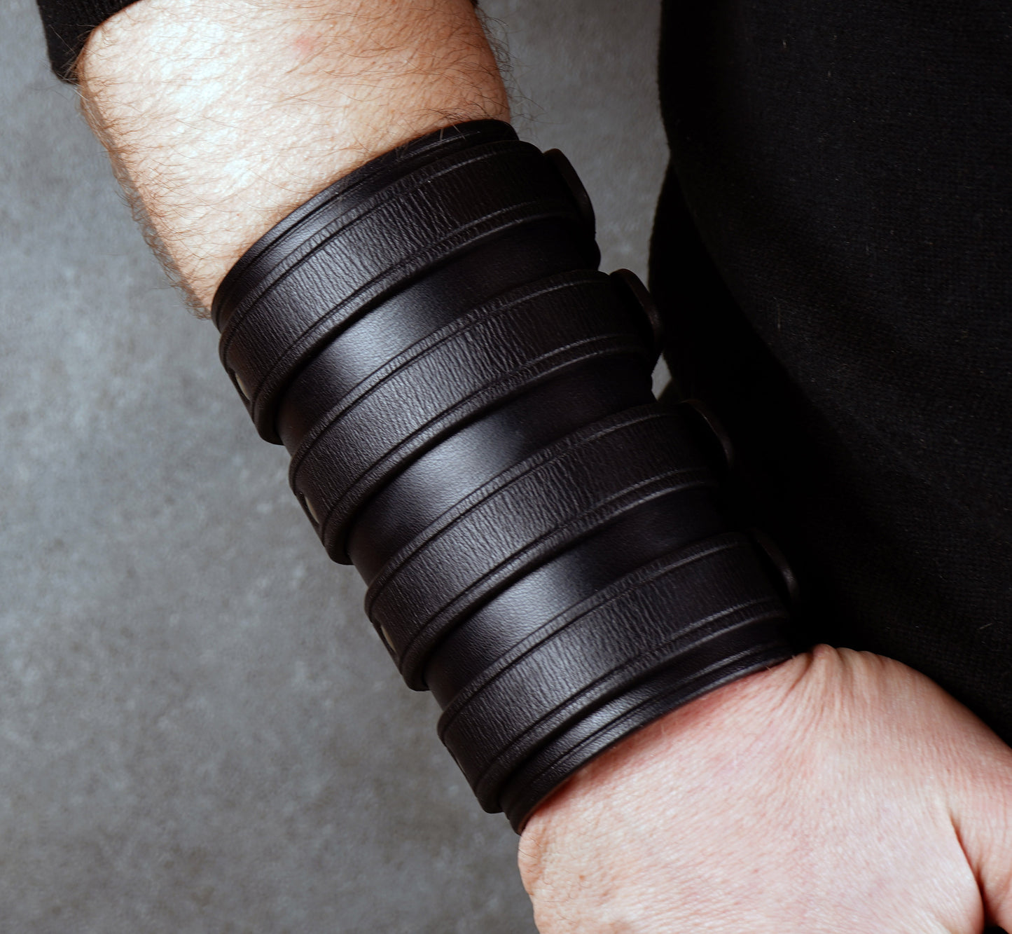 Wide black leather cuff bracelet handmade from vegetable-tanned leather with minimalist design
