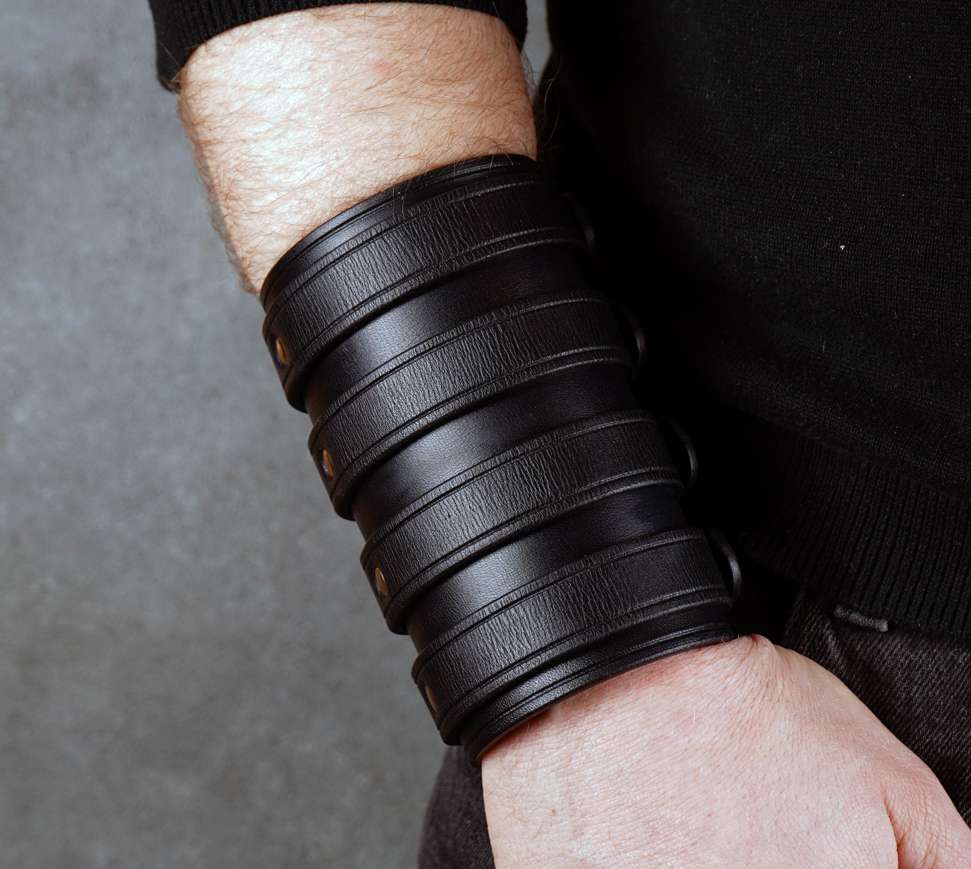 Wide black leather cuff bracelet handmade from vegetable-tanned leather with minimalist design