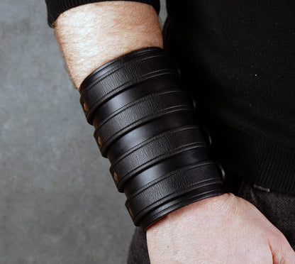 Wide black leather cuff bracelet handmade from vegetable-tanned leather with minimalist design