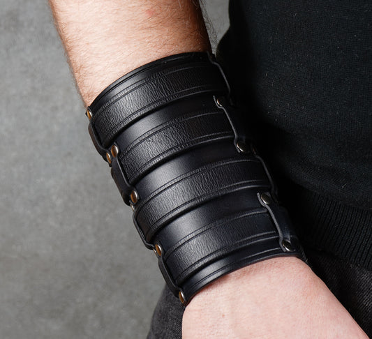 Wide black leather cuff bracelet handmade from vegetable-tanned leather, minimalist design
