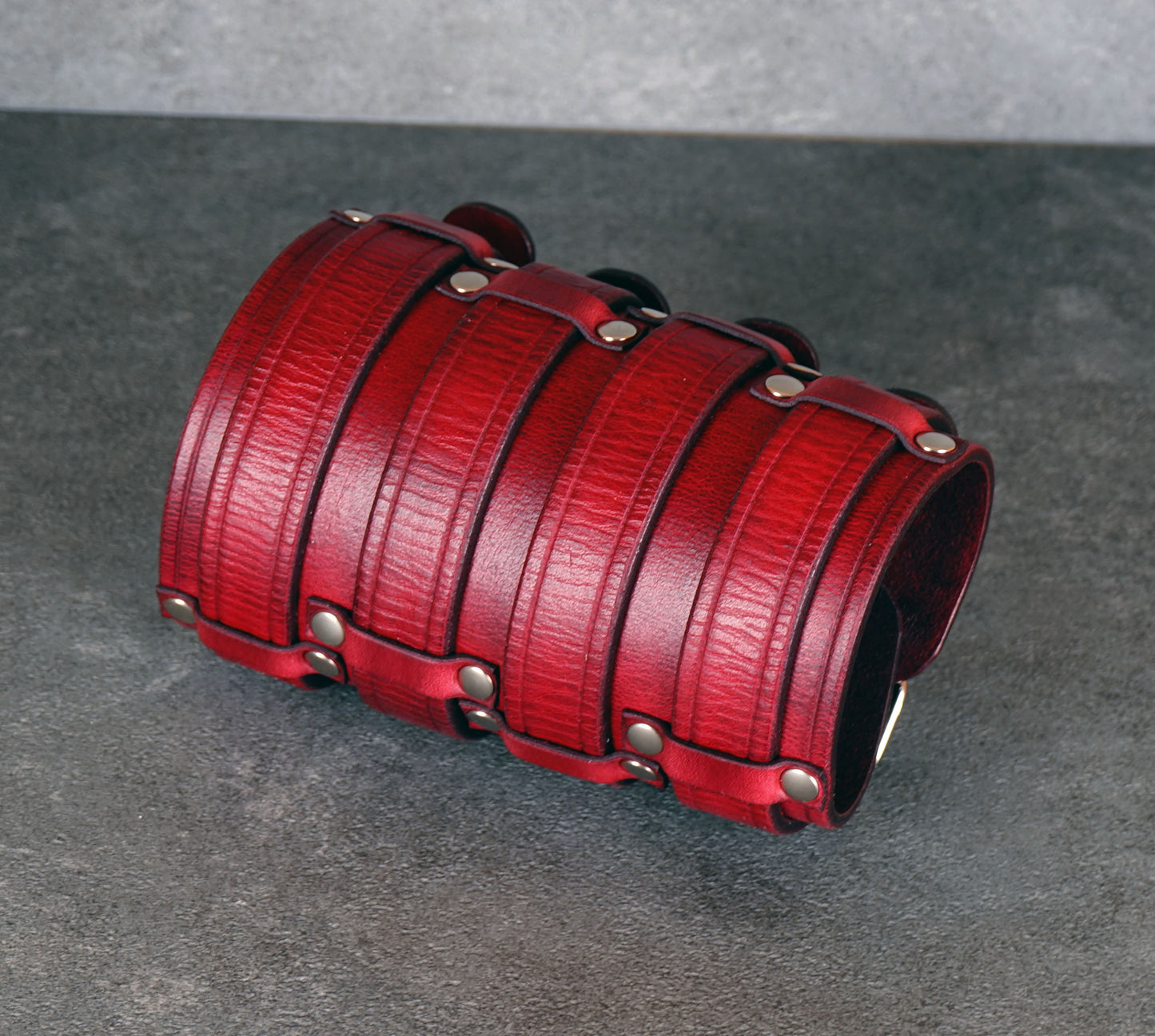 Wide red leather cuff bracelet handmade from vegetable-tanned leather, minimalist design