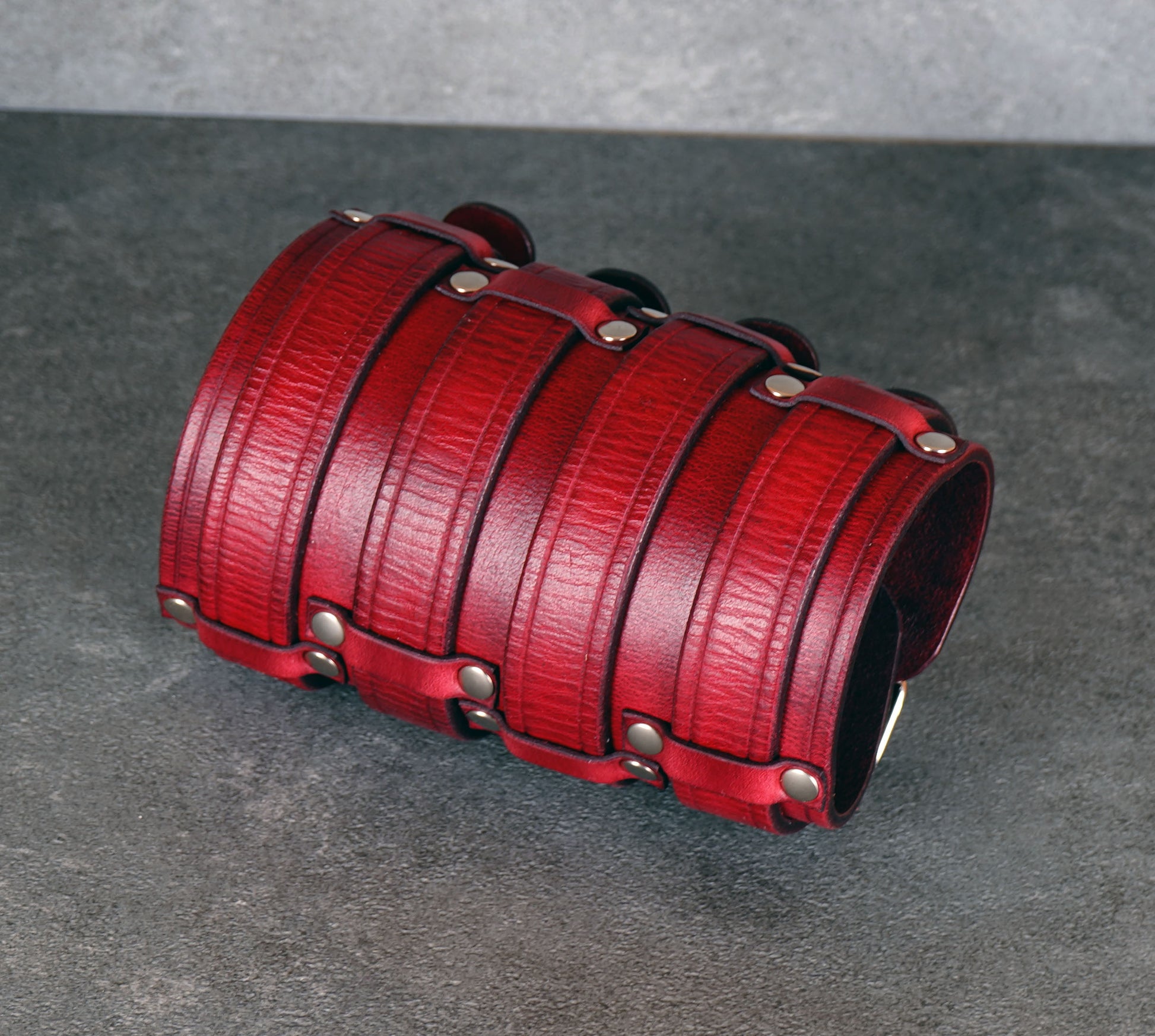 Wide red leather cuff bracelet handmade from vegetable-tanned leather, minimalist design