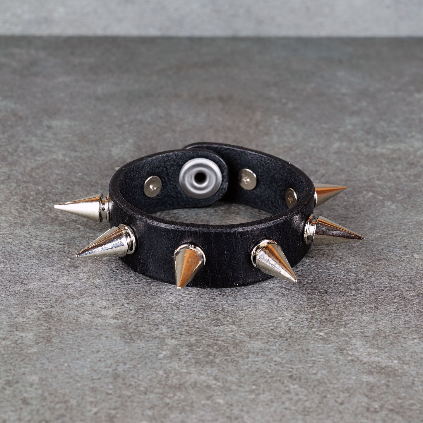 Punk-inspired black leather wristband close-up
