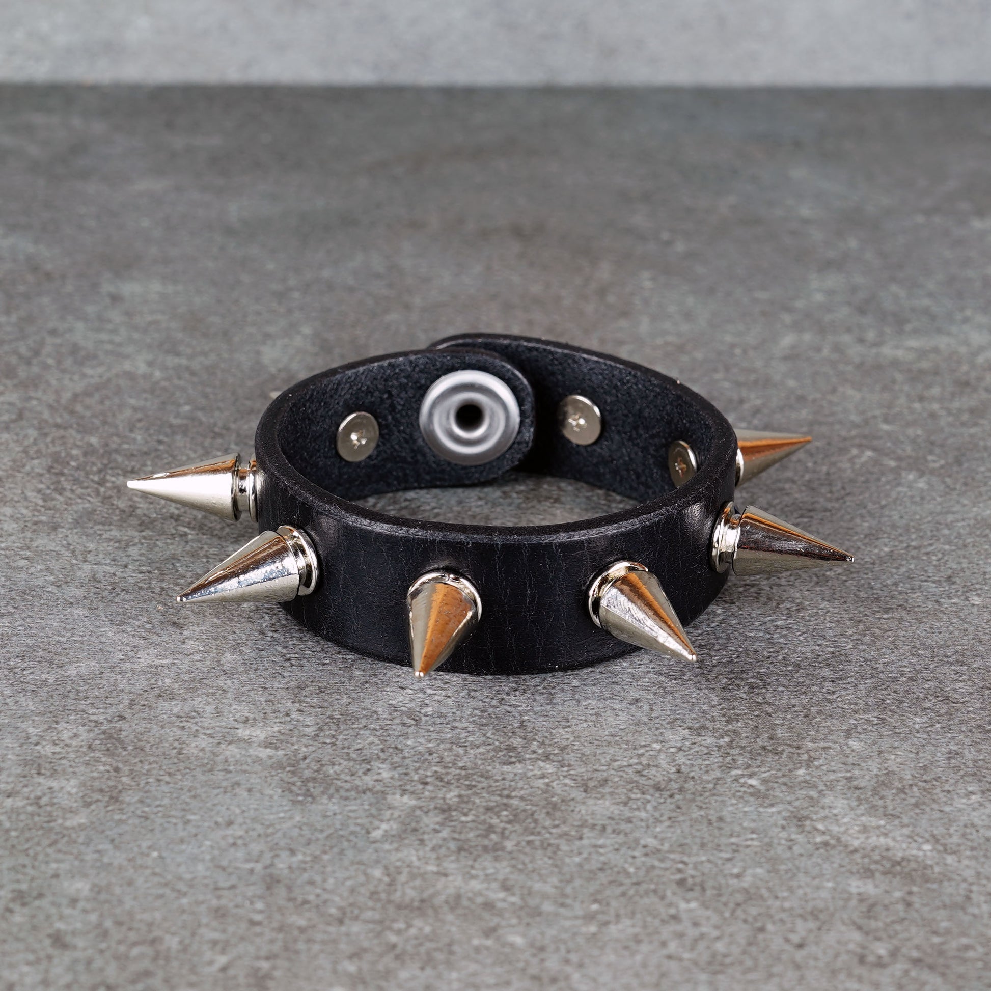 Punk-inspired black leather wristband close-up
