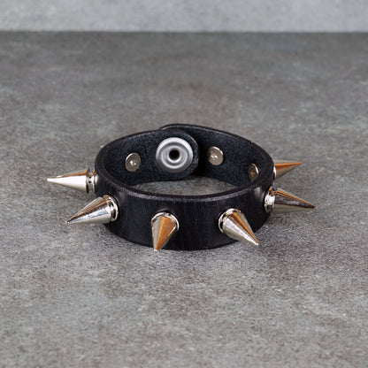 Punk-inspired black leather wristband close-up