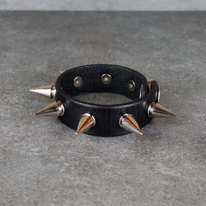 Black leather bracelet styled for punk rock outfits