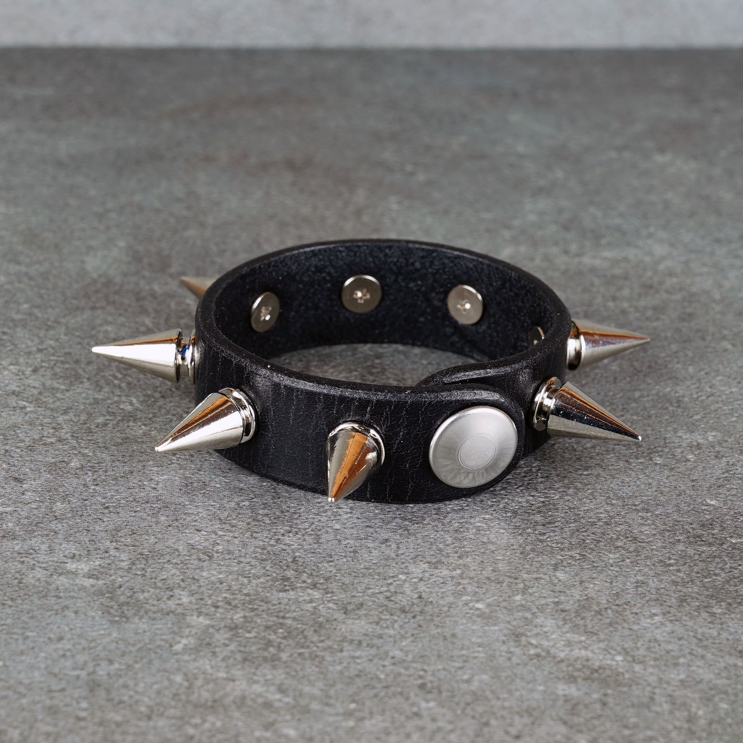 Punk-inspired black leather wristband close-up