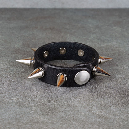 Punk-inspired black leather wristband close-up