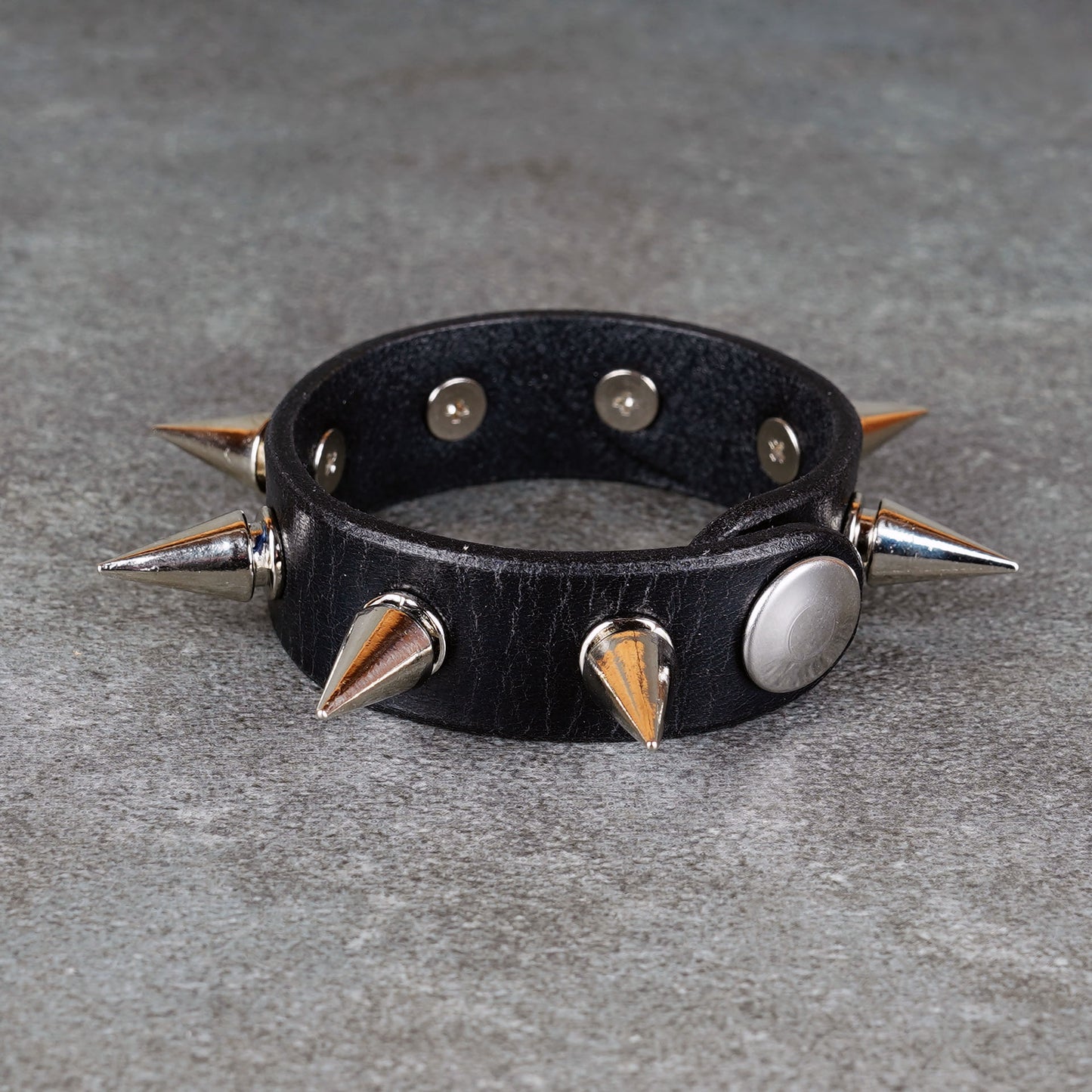 Black leather bracelet styled for punk rock outfits