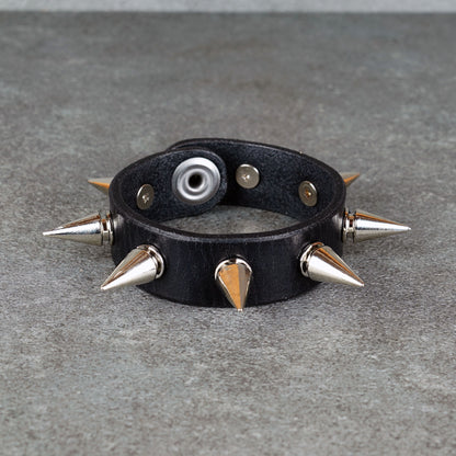 Black leather bracelet styled for punk rock outfits