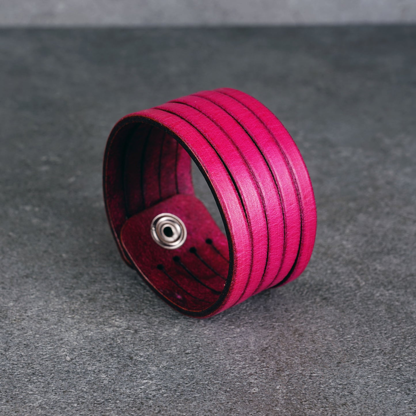 Pink leather wrap bracelet worn on wrist, handmade genuine leather cuff bracelet with layered strap design, minimalist magenta wristband for men and women
