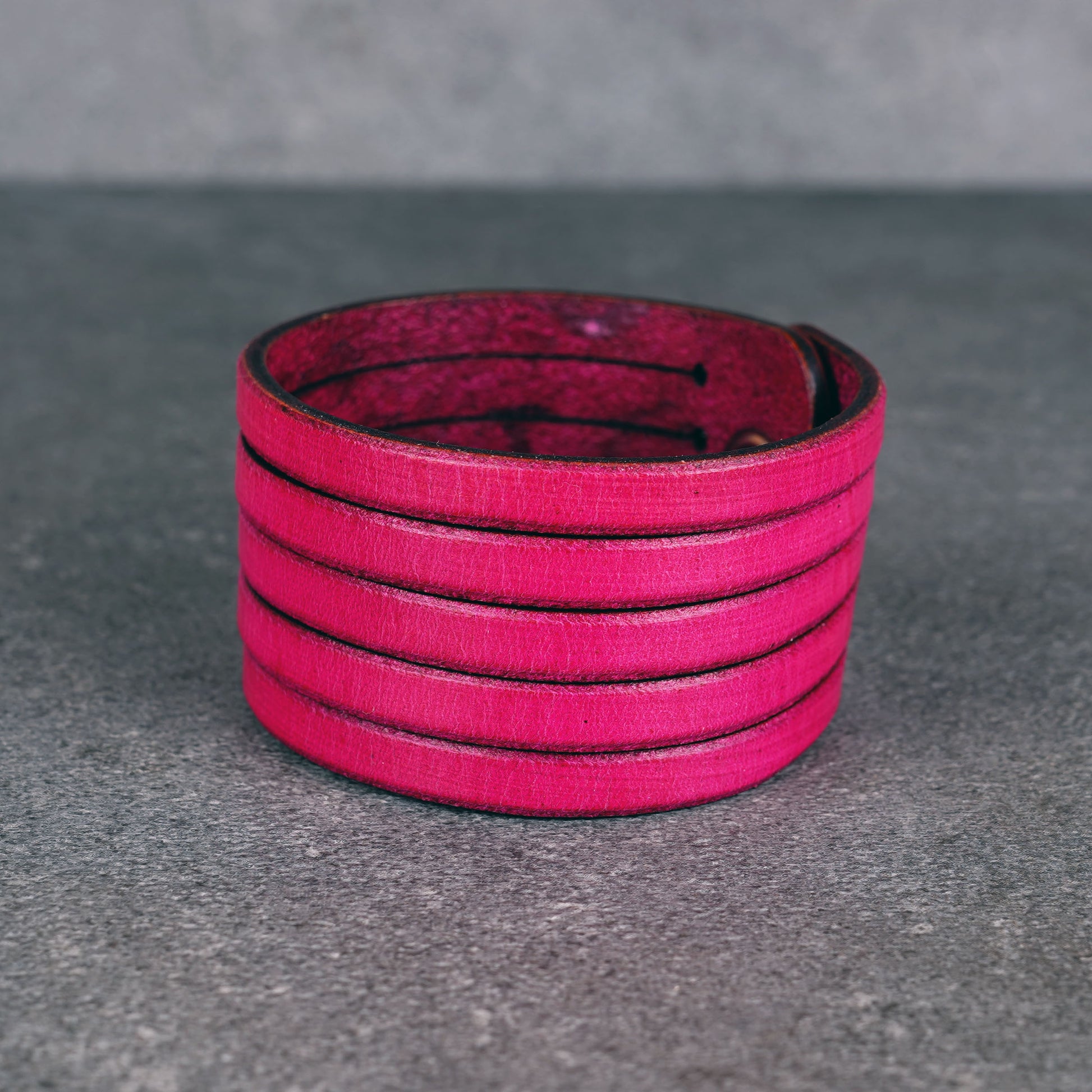 Pink leather wrap bracelet worn on wrist, handmade genuine leather cuff bracelet with layered strap design, minimalist magenta wristband for men and women
