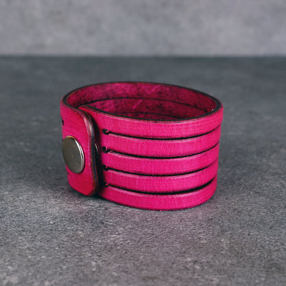 Pink leather wrap bracelet worn on wrist, handmade genuine leather cuff bracelet with layered strap design, minimalist magenta wristband for men and women
