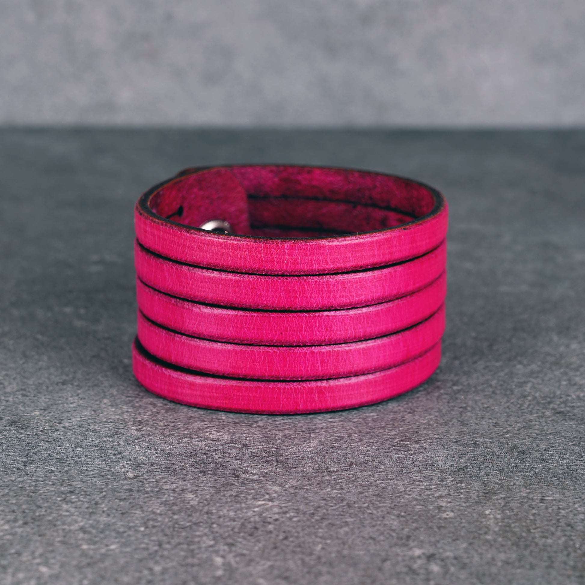 Pink leather wrap bracelet worn on wrist, handmade genuine leather cuff bracelet with layered strap design, minimalist magenta wristband for men and women
