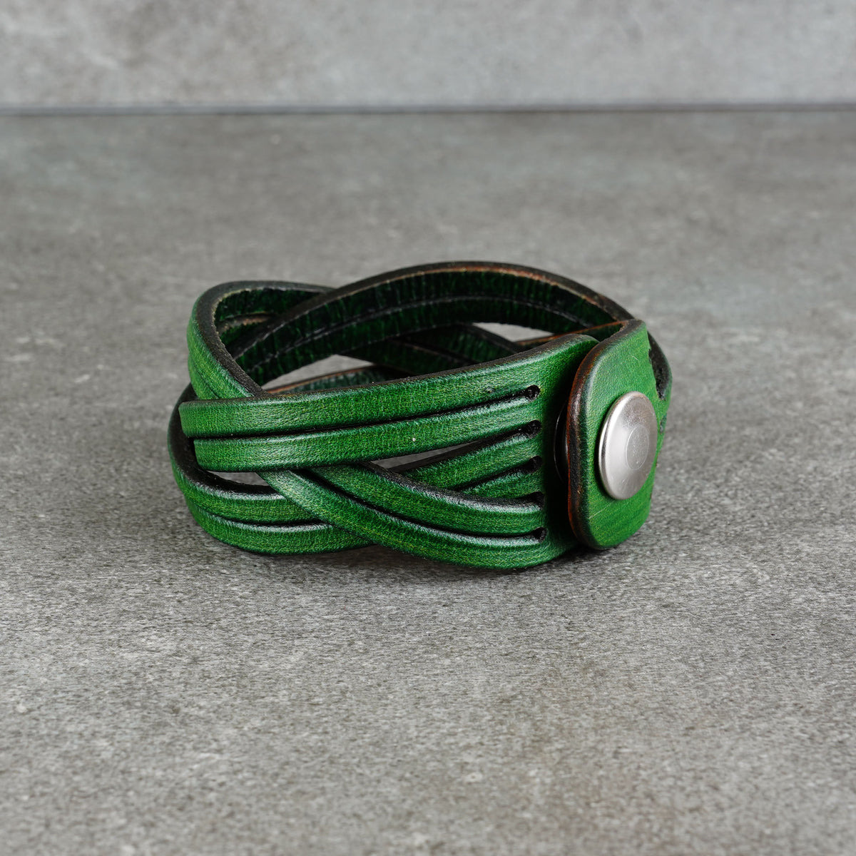Side view highlighting the layered woven band and snap closure