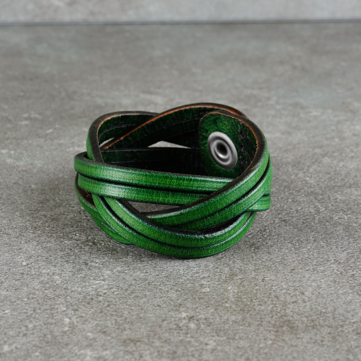 Front-left view of the cuff showing the wrapped leather strips
