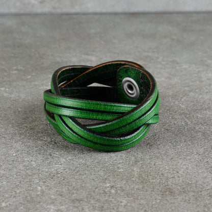 Front-left view of the cuff showing the wrapped leather strips