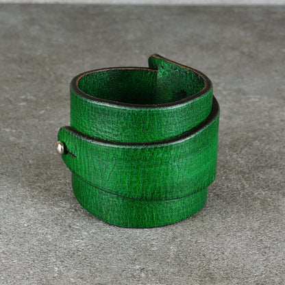 Upright green leather cuff bracelet with the opening facing forward