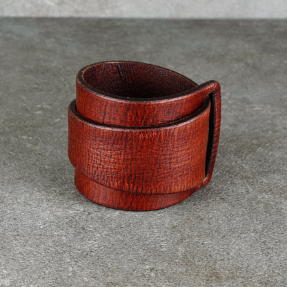 Brown cuff bracelet upright with the layered bands wrapped around
