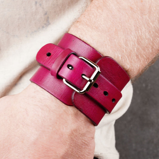 Violet leather cuff bracelet shown on a wrist with a metal buckle and visible holes