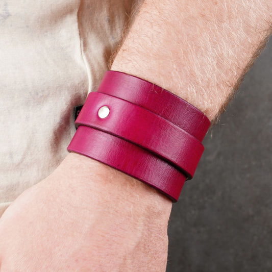 Close-up of the buckle area on a violet leather cuff bracelet worn on the wrist